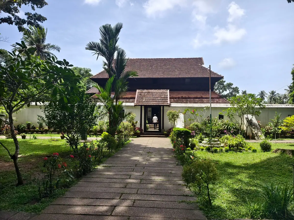 Traditional Kerala home surrounded by lush greenery