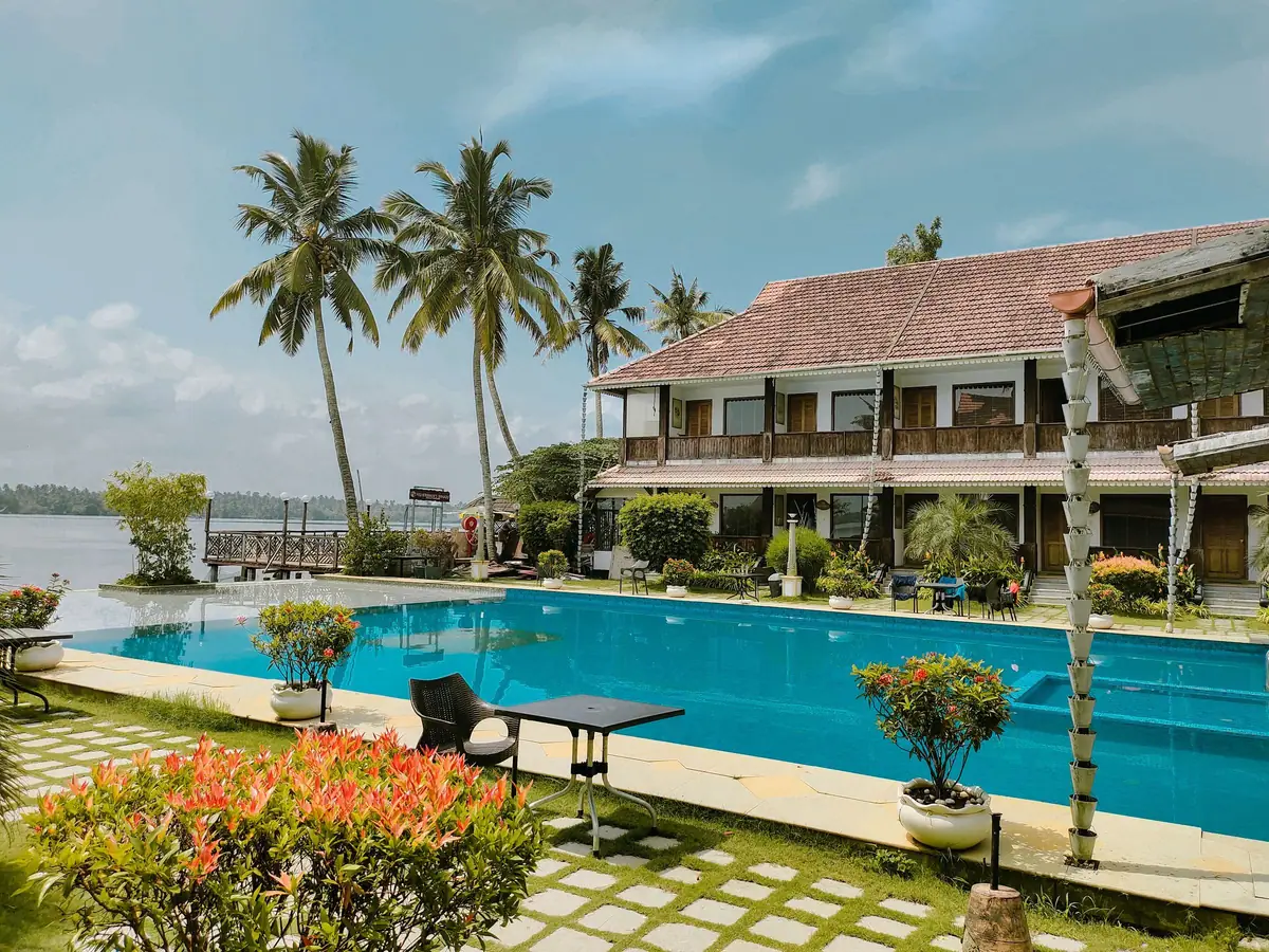 Kerala resort with a pool and coconut palms