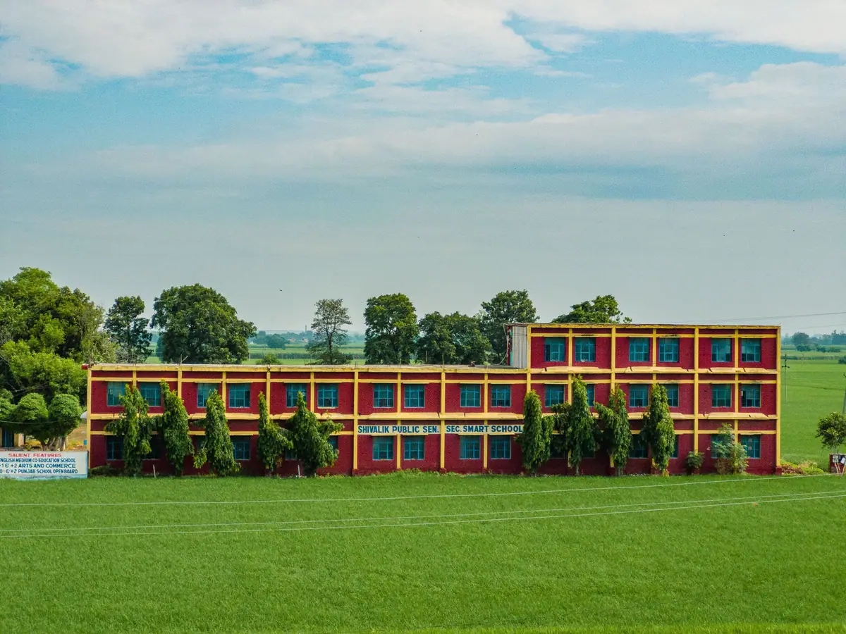 School building with green grounds in India