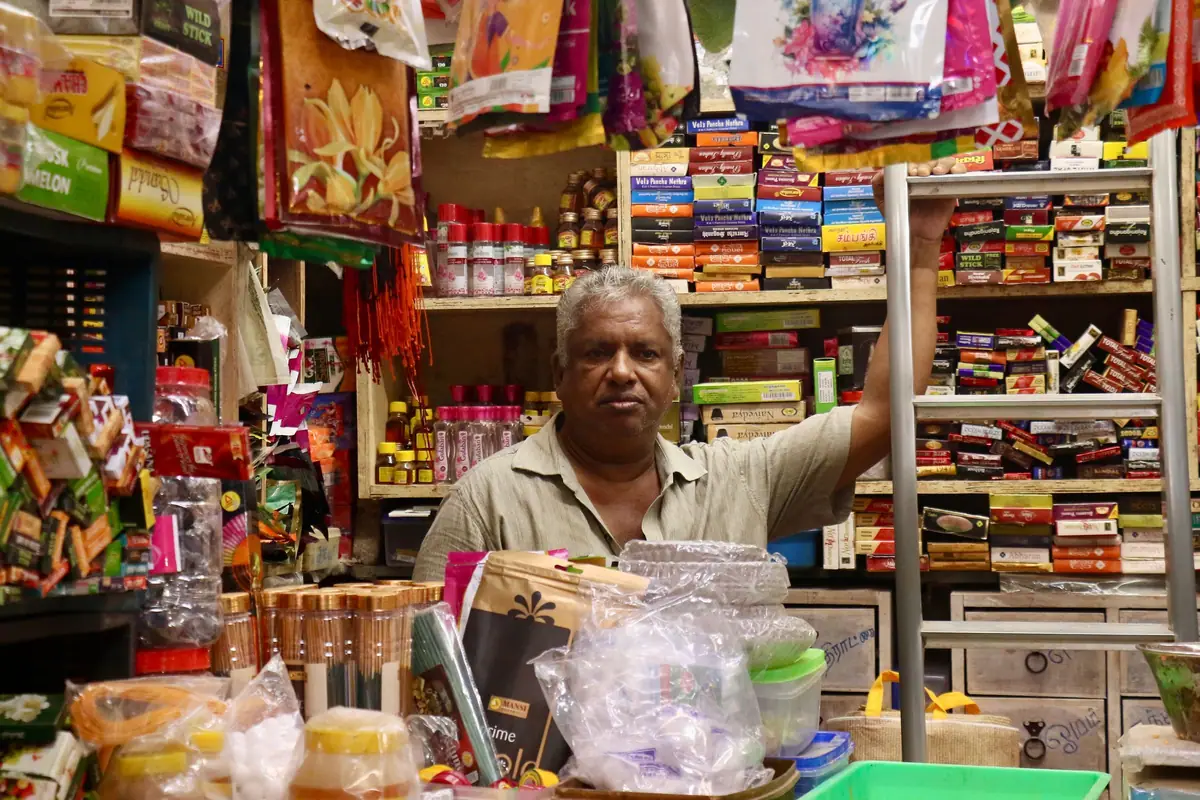 Shopkeeper in a busy Indian grocery store