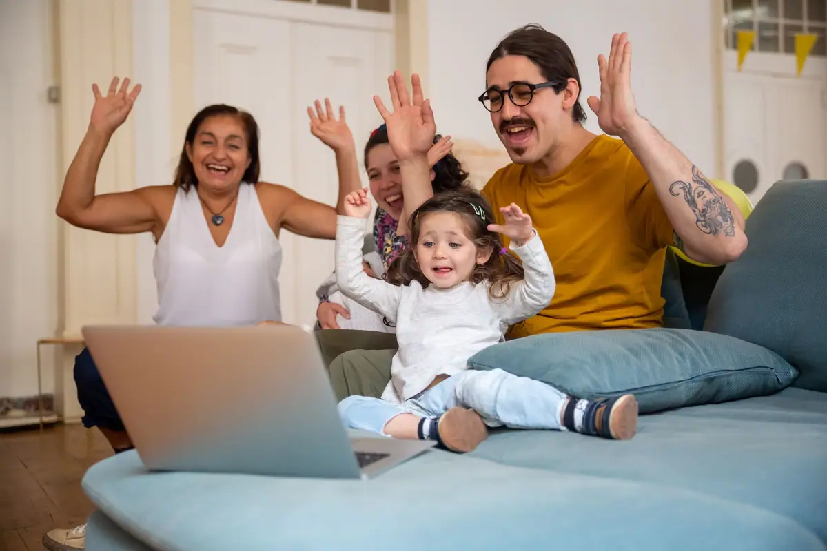 Family waving on a video call